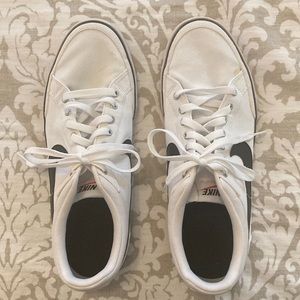 White Nike sneakers with black swoosh. Mens size 11 or unisex.